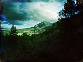 Scenic view of mountains against cloudy sky