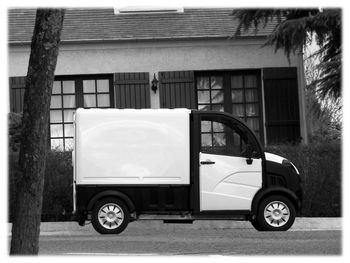 Side view of car on street against building