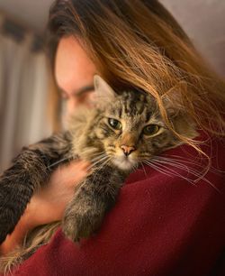 Young woman with cat at home