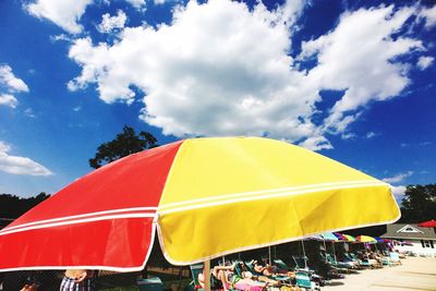 Multi colored umbrellas on beach against sky