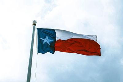 Low angle view of texas flag against sky