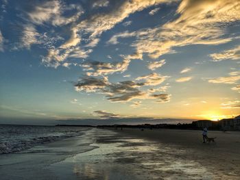 Scenic view of beach against sky during sunset