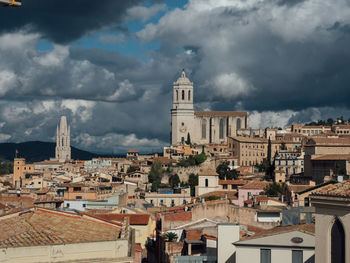 Buildings in town against sky