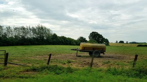 Hay bales on field against sky