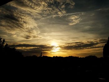 Silhouette trees against sky during sunset