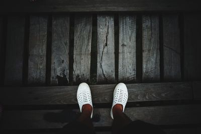 Low section of woman on footbridge