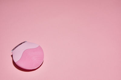 High angle view of pink umbrella against colored background