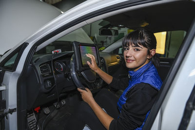 Portrait of young woman in car