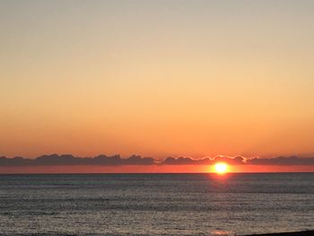 Scenic view of sea against clear sky during sunset