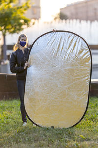 Full length of young woman holding glass