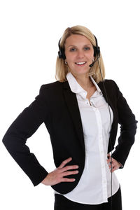 Portrait of a smiling young woman standing against white background