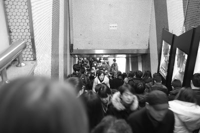 Crowds walking on steps at subway station