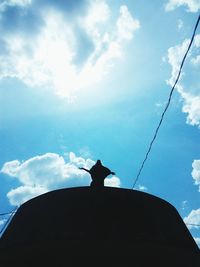 Low angle view of silhouette statue against sky