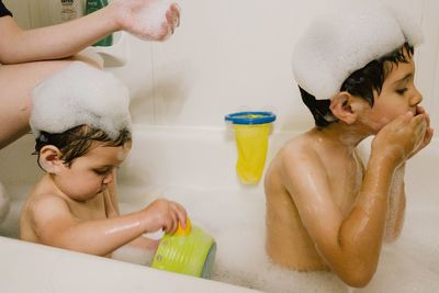 Two young children taking a bath at home