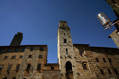 Low angle view of old building against blue sky