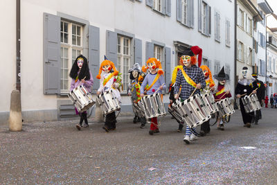 Switzerland, basel, 8 march 22. group of carnival snare drummers in costumes