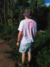 Full length of teenage girl standing in forest