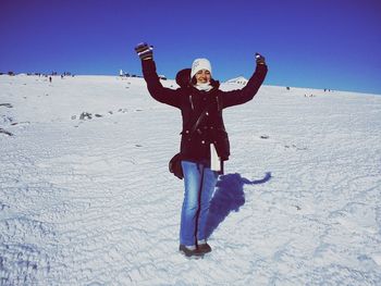 Full length of woman on snow covered land