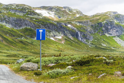 End of road sign in mountains