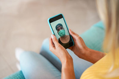 Midsection of man using mobile phone