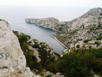 High angle view of rocks by sea against sky