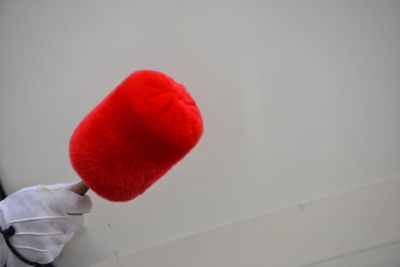 Close-up of hand holding heart shape against white background