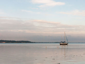 Sailboat on sea against sky