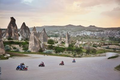 Tourists riding quadbikes in desert