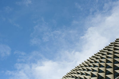 Low angle view of sculpture on roof against sky