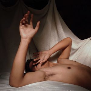 Midsection of woman lying on bed