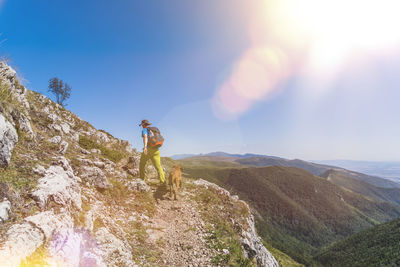 Man standing on mountain against sky