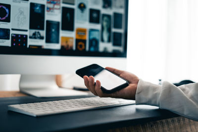 Midsection of woman using laptop on table