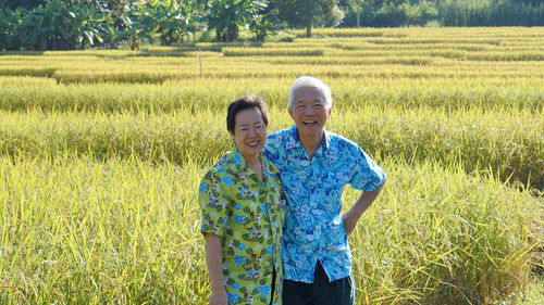 Asian senior elder couole hawaii shirts with agriculture rice farm