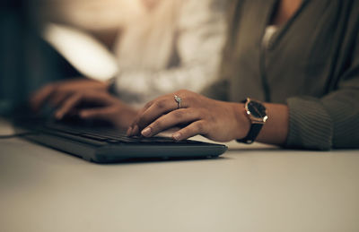 Midsection of woman using laptop