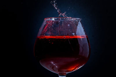 Close-up of red wine against black background