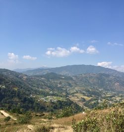 Scenic view of landscape against blue sky