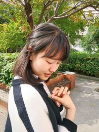 Smiling young woman in park