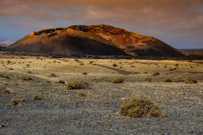 Scenic view of arid landscape against sky