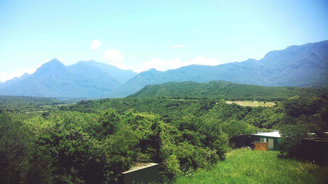 mountain, mountain range, tranquil scene, landscape, tranquility, beauty in nature, scenics, nature, tree, sky, green color, non-urban scene, growth, house, idyllic, clear sky, field, grass, remote, day