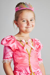 Little girl enjoying her role of princess. adorable cute 5-6 years old girl wearing princess dress