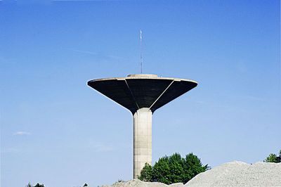 Low angle view of water tower against blue sky