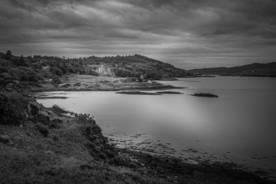 Black and white panorama of the bay of dunvegan loch with dunvegan castle