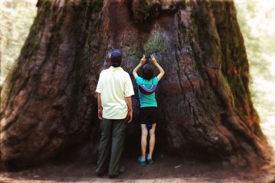 Rear view of men on rock