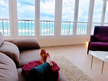 Woman relaxing on sofa at home