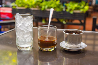 Close-up of beer glasses on table