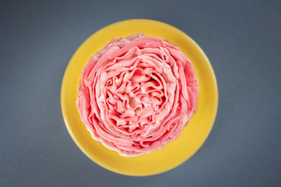 High angle view of pink cake against black background