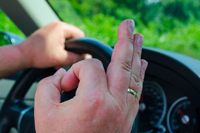Close-up of human hand on car