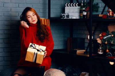 Portrait of woman sitting in box