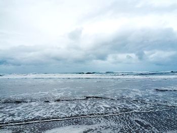 Scenic view of sea against cloudy sky