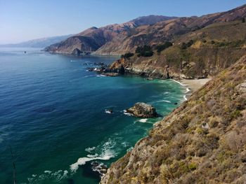 Scenic view of sea and mountains against sky